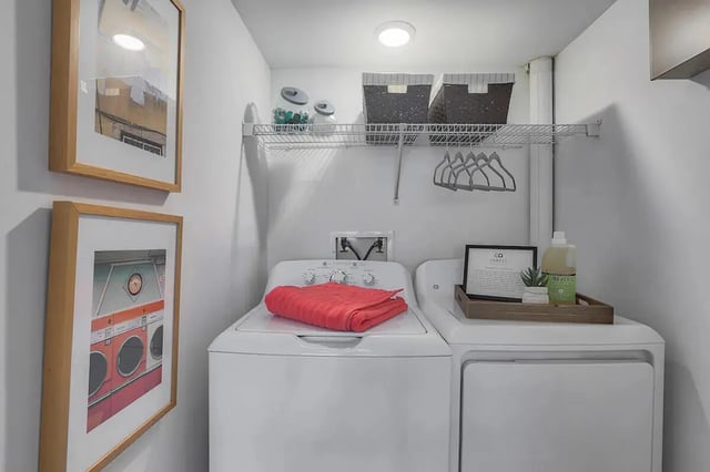 Washer dryer framed art and shelf Laundry room at Tremont Student Living in State College Student Accommodation