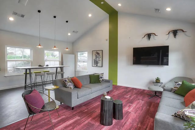 Modern lounge with sofas and high table living room at Tremont Student Living in State College Student Accommodation