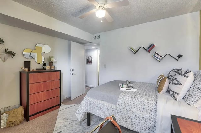Bed dresser mirrors books and fan bedroom at Tremont Student Living in State College Student Accommodation