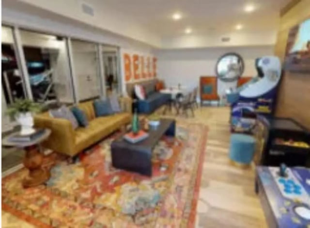 Sofas coffee table arcade games living room at Luxe Belle in Columbus Student Accommodation