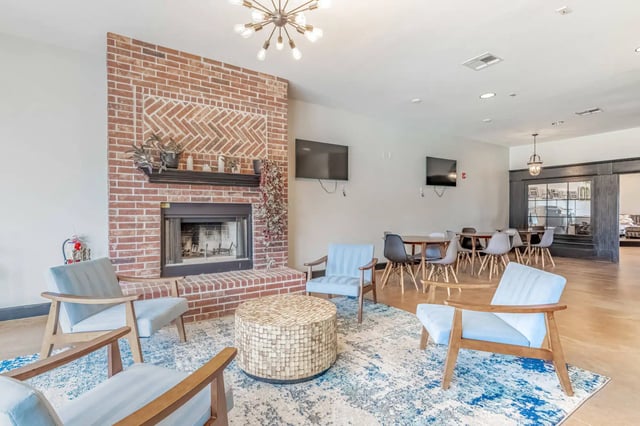 Chairs fireplace coffee table television communal area living room at 2909 Oliver in Wichita Student Accommodation