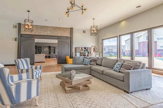 Sofa chairs coffee table modern chandelier lounge area at 2909 Oliver in Wichita Student Accommodation