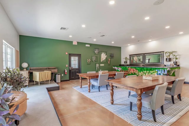 Wooden tables and chairs for activities common area at 2909 Oliver in Wichita Student Accommodation