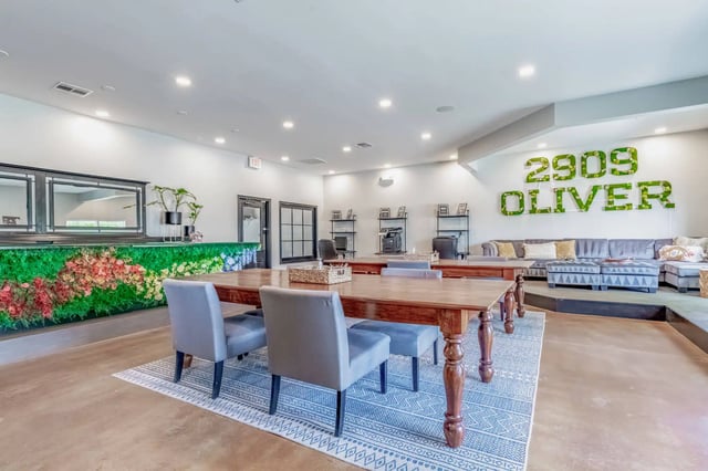 Dining tables chairs and lounge sofas communal area at 2909 Oliver in Wichita Student Accommodation