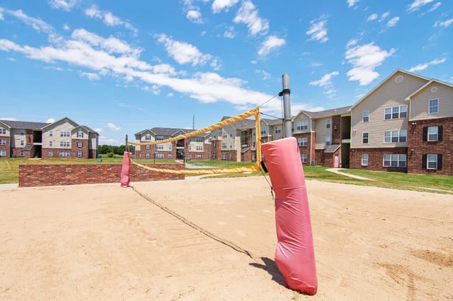 Volleyball court net and apartment buildings exterior at 2909 Oliver in Wichita Student Accommodation