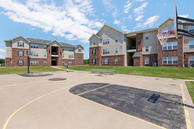 Basketball court with apartments and grass exterior at 2909 Oliver in Wichita Student Accommodation