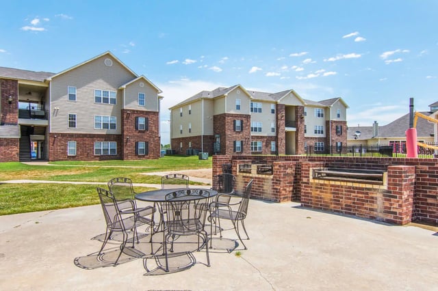 Metal table chairs and outdoor grill exterior at 2909 Oliver in Wichita Student Accommodation
