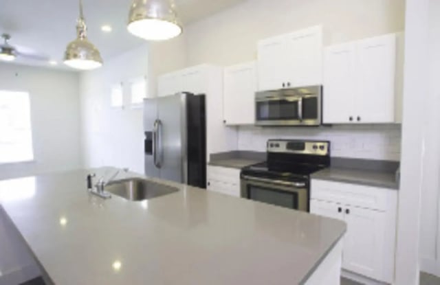 Modern kitchen with island and appliances kitchen at The District at Clemson in Clemson Student Accommodation