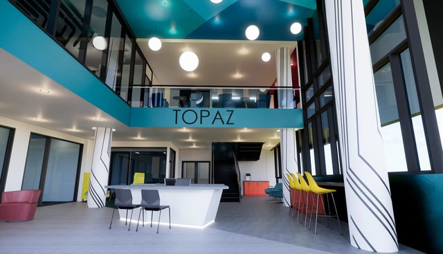 Reception desk chairs couches and bar stools communal area at Topaz in San Diego Student Accommodation