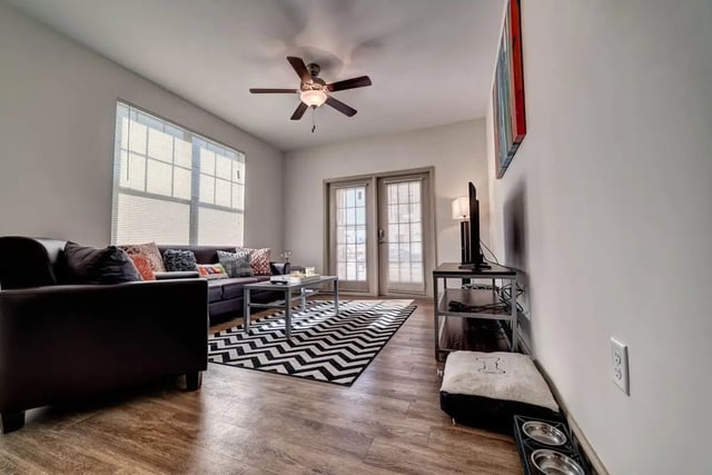 Sofa coffee table rug and TV stand living room at Riverfront Village in Tuscaloosa Student Accommodation