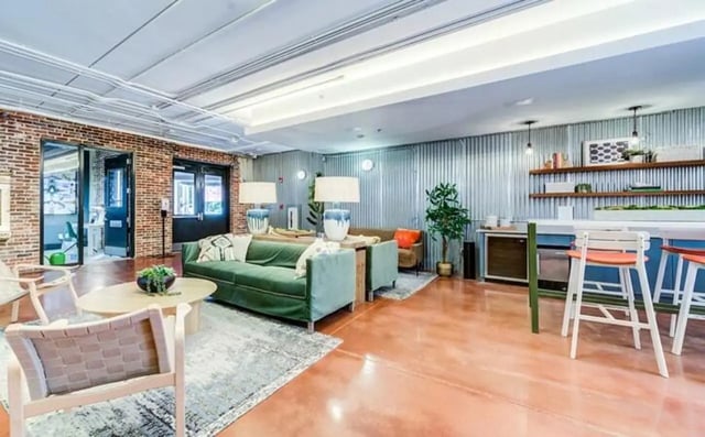 Green sofa with chairs and tables living area at The Warehouse Apartments Chapel Hill in Chapel Hill Student Accommodation