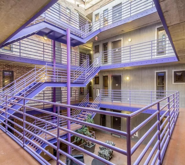 Purple staircase and railings of building exterior at The Warehouse Apartments Chapel Hill in Chapel Hill Student Accommodation