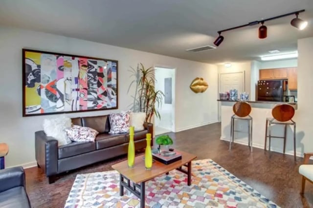 Modern living room with artwork and kitchen island living room at Gateway at Huntsville in Huntsville Student Accommodation