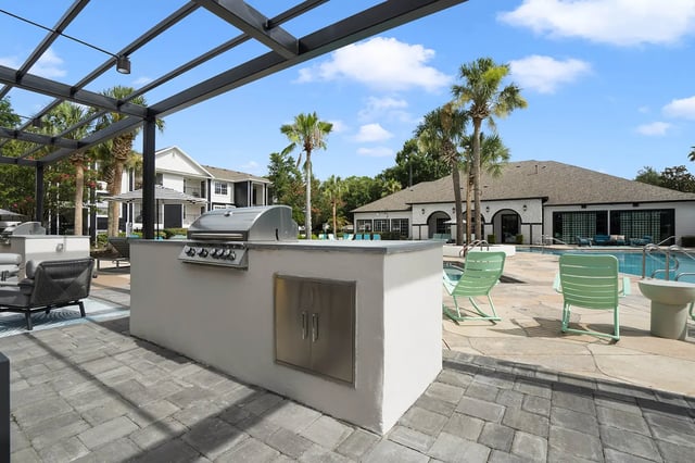 Grill and seating area by pool exterior at On20 Apartments in Gainesville Student Accommodation