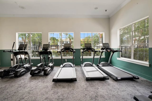 Ellipticals and treadmills with screens gym area at On20 Apartments in Gainesville Student Accommodation