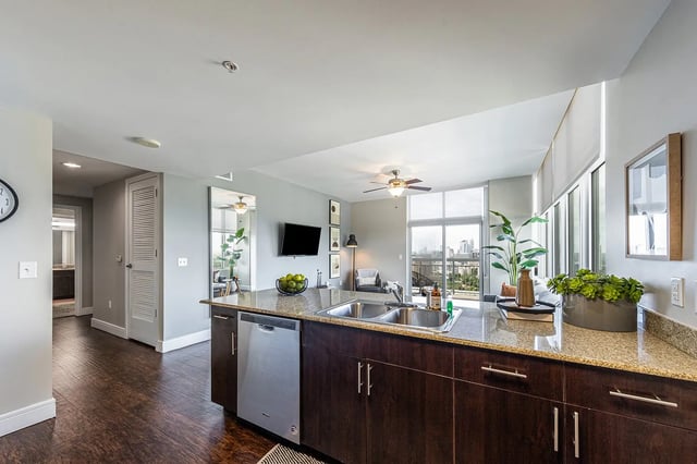 Modern kitchen island dishwasher sink living room at 21 Rio in Austin Student Accommodation