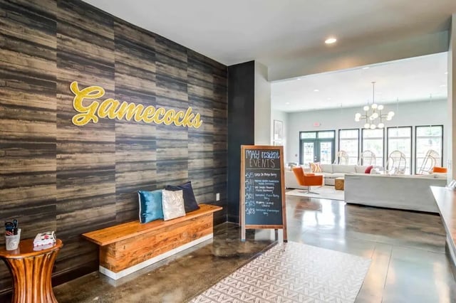 Gamecocks sign wooden bench chalkboard lounge living room at Gamecock Village in Jacksonville Student Accommodation