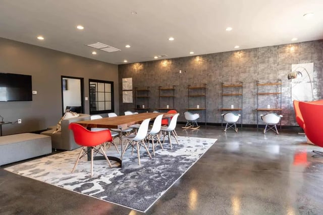 Dining table with chairs and lounge seating common area at Gamecock Village in Jacksonville Student Accommodation