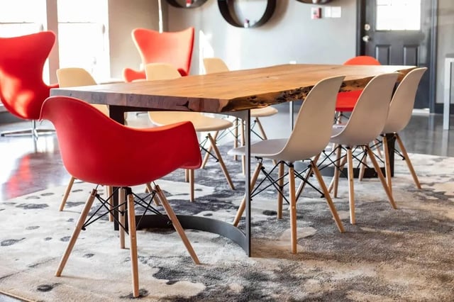 Wooden table with red and white chairs communal area at Gamecock Village in Jacksonville Student Accommodation