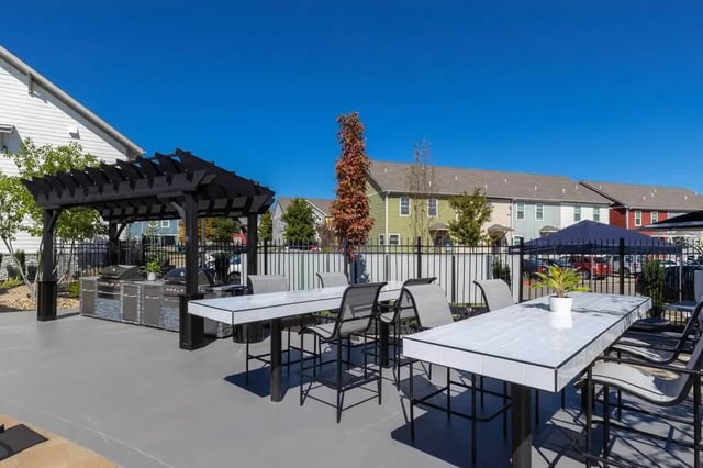 BBQ grills bar tables and chairs outdoor area at The Collective at Columbia Apartments in Columbia Student Accommodation