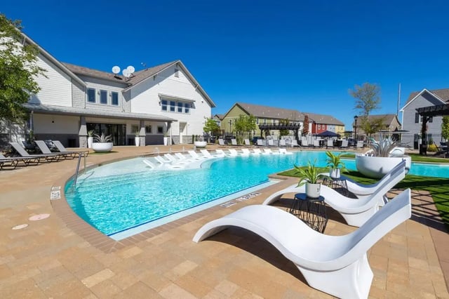 Modern pool loungers and blue water swimming pool exterior at The Collective at Columbia Apartments in Columbia Student Accommodation