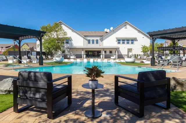 Chairs pool and building exterior at The Collective at Columbia Apartments in Columbia Student Accommodation