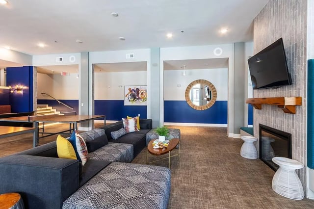 Sofa coffee table fireplace TV living room at Eastern on 10th in Greenville Student Accommodation