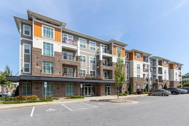 Apartment building with balconies parking lot exterior at Eastern on 10th in Greenville Student Accommodation