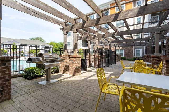 Grill yellow chairs white tables outdoor area at Eastern on 10th in Greenville Student Accommodation