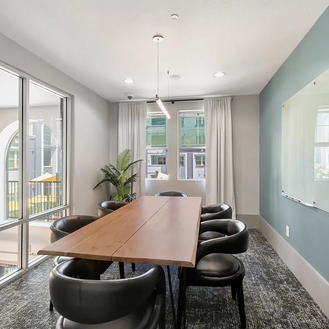 Large wooden table eight black chairs study area at Iconic on Alvarado in San Diego Student Accommodation