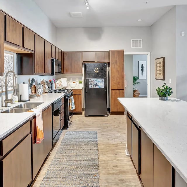 Modern kitchen with dark cabinets stainless steel appliances kitchen at Iconic on Alvarado in San Diego Student Accommodation