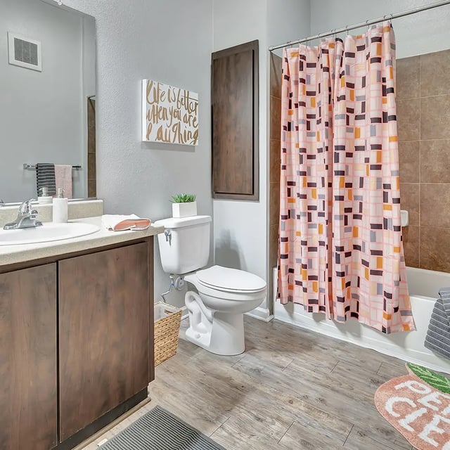 Sink toilet bathtub patterned shower curtain bathroom at Iconic on Alvarado in San Diego Student Accommodation