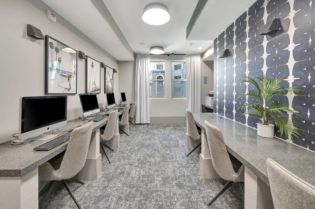 Computers and chairs in a modern study area at Iconic on Alvarado in San Diego Student Accommodation