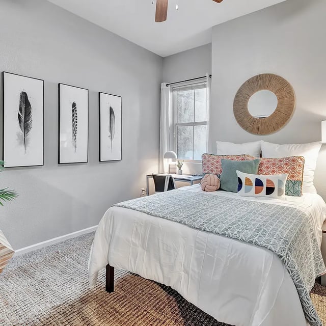 Bed desk and decorative pillows bedroom at Iconic on Alvarado in San Diego Student Accommodation