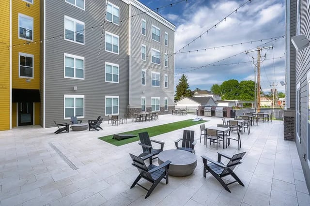 Paved courtyard with fire pit tables and grills exterior at Vue on Walnut in Springfield Student Accommodation