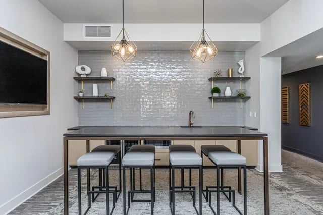 Bar stools and counter with shelving and sink area. at Vue on Walnut in Springfield Student Accommodation