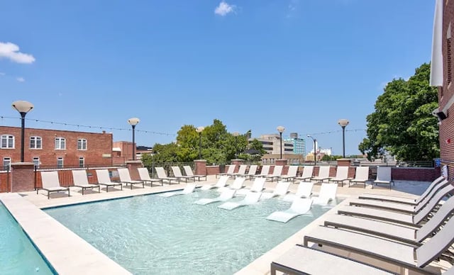Rooftop pool with lounge chairs and city view exterior at Vue on Walnut in Springfield Student Accommodation