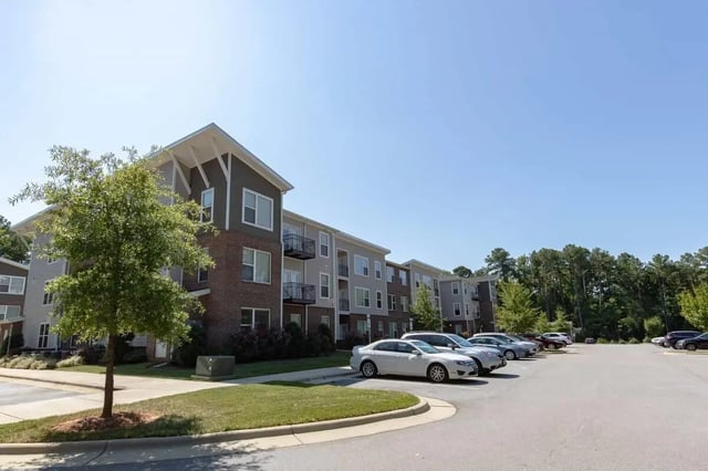 Apartment building with cars parked outside exterior at 1820 at Centennial in Raleigh Student Accommodation