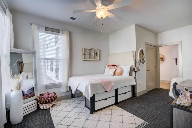 Bed with drawers mirror and decor bedroom at 1820 at Centennial in Raleigh Student Accommodation