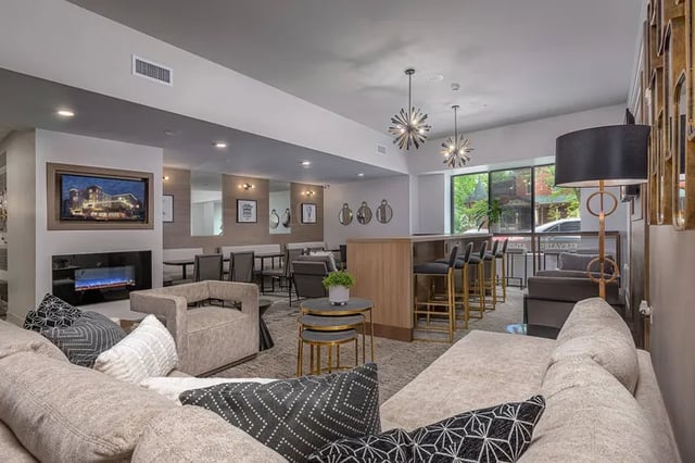 Sofa fireplace bar stools and seating area living room at Vue on Walnut in Springfield Student Accommodation
