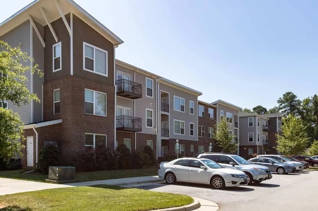 Modern apartment building with cars exterior at 1820 at Centennial in Raleigh Student Accommodation