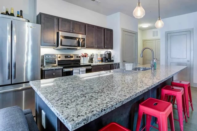 Stainless steel fridge stove microwave granite island kitchen at 1820 at Centennial in Raleigh Student Accommodation