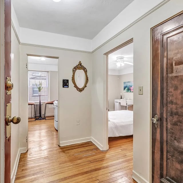 Hallway with ornate mirror and doorway to bedroom interior at Howe Place Apartments in New Haven Student Accommodation