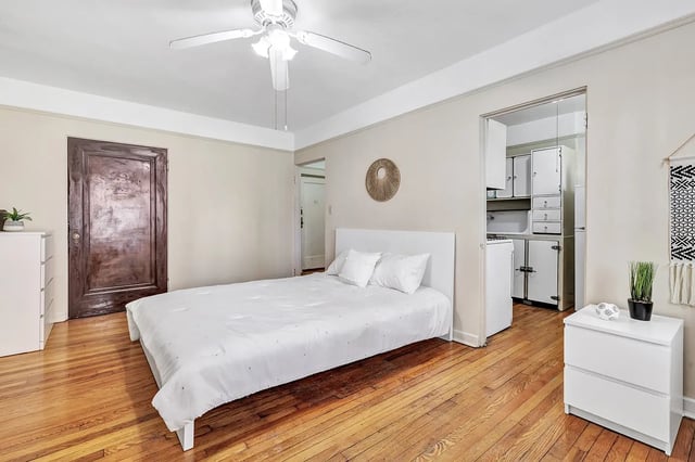 Bed white dresser door and kitchen bedroom at Howe Place Apartments in New Haven Student Accommodation