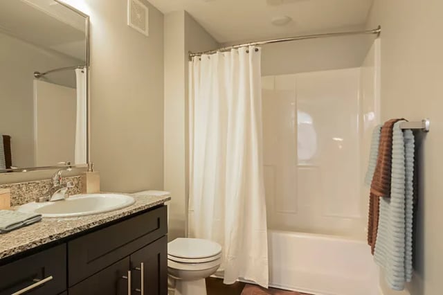Sink toilet shower with white curtain bathroom at The Lookout on Cragmor in Colorado Springs Student Accommodation