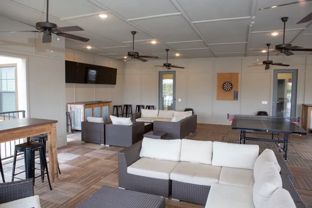 Sofas bar dartboard ping pong table recreation area at Balcony Starkville in Starkville Student Accommodation