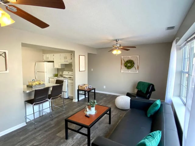 Sofa chairs tables kitchen counter living room exterior at 1909 Campus Flats in Bowling Green Student Accommodation