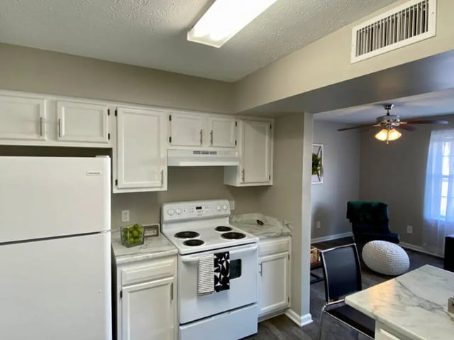 White refrigerator stove cabinets white kitchen. at 1909 Campus Flats in Bowling Green Student Accommodation