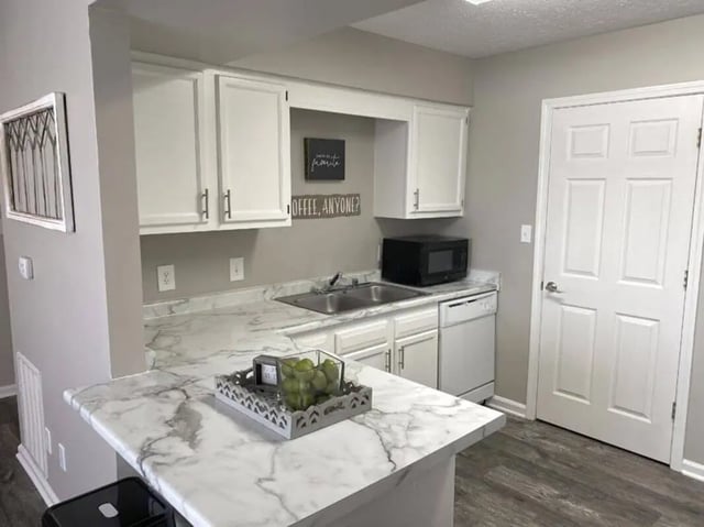 White cabinets marble counters microwave dishwasher kitchen at 1909 Campus Flats in Bowling Green Student Accommodation