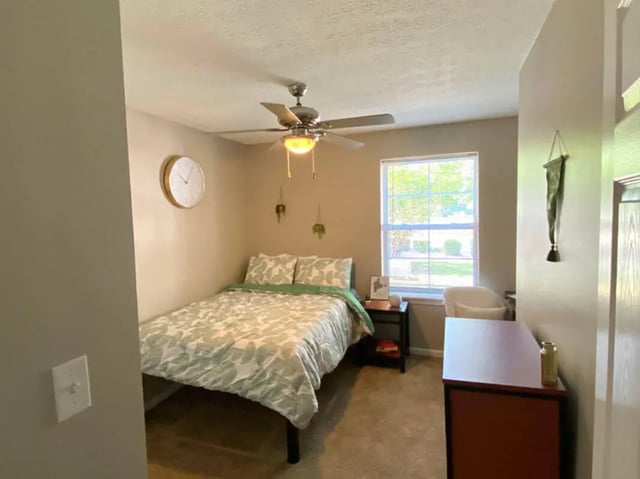 Bed fan clock dresser and window bedroom at 1909 Campus Flats in Bowling Green Student Accommodation